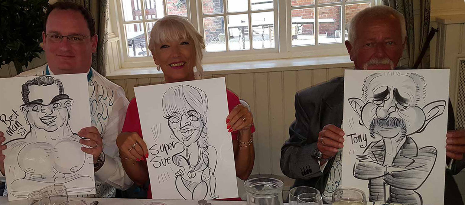 top table are showing the camera their caricatures