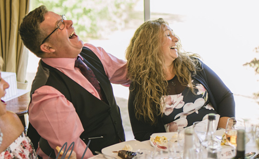 couple laughing at the cartoon at a Wedding