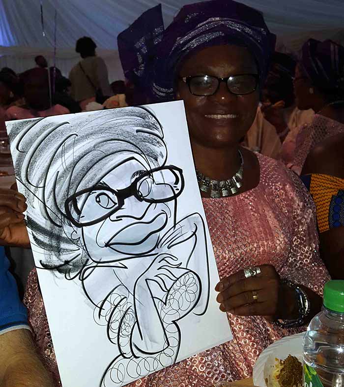 guest posing with her caricature keepsake