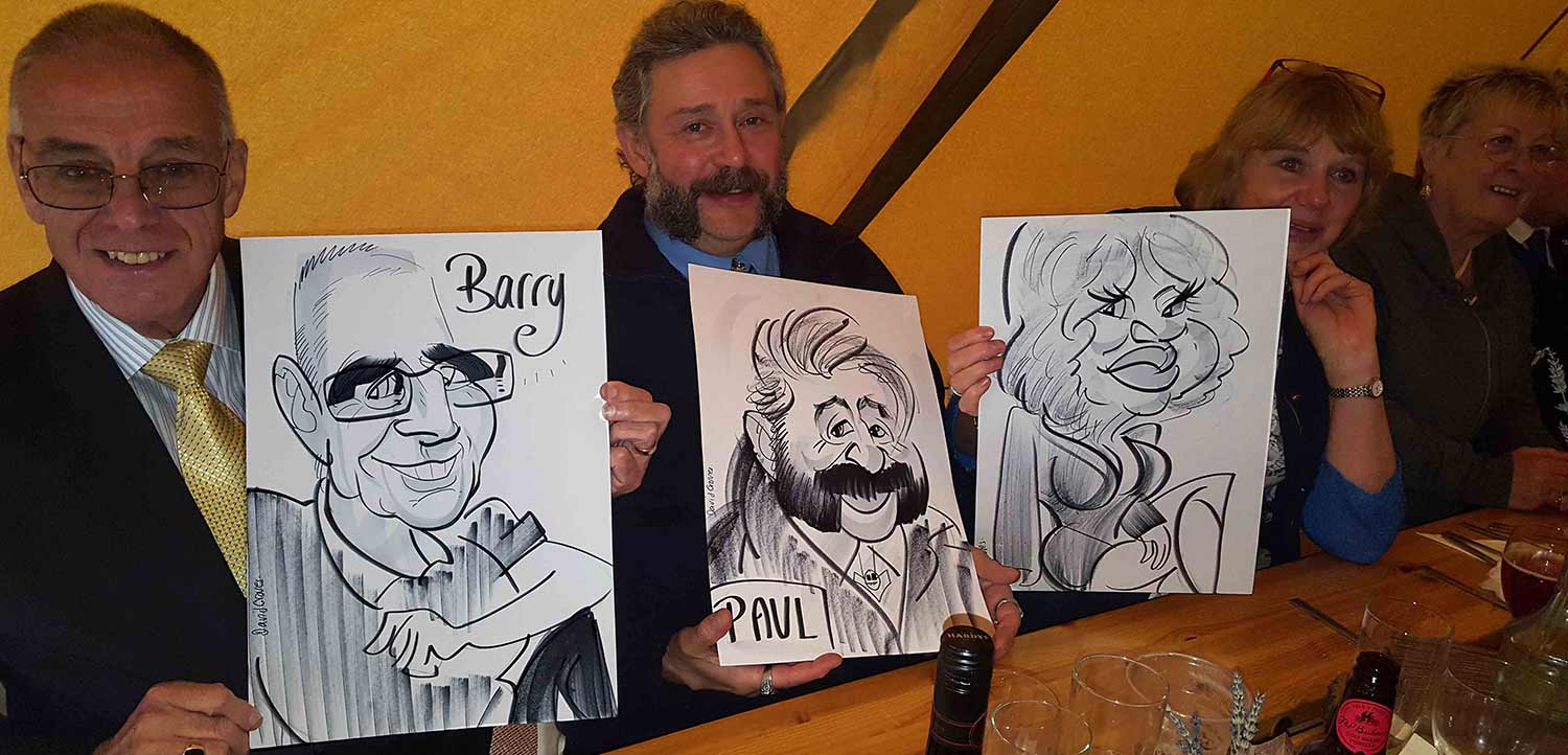 Guests pose with their caricature in a tipi tent