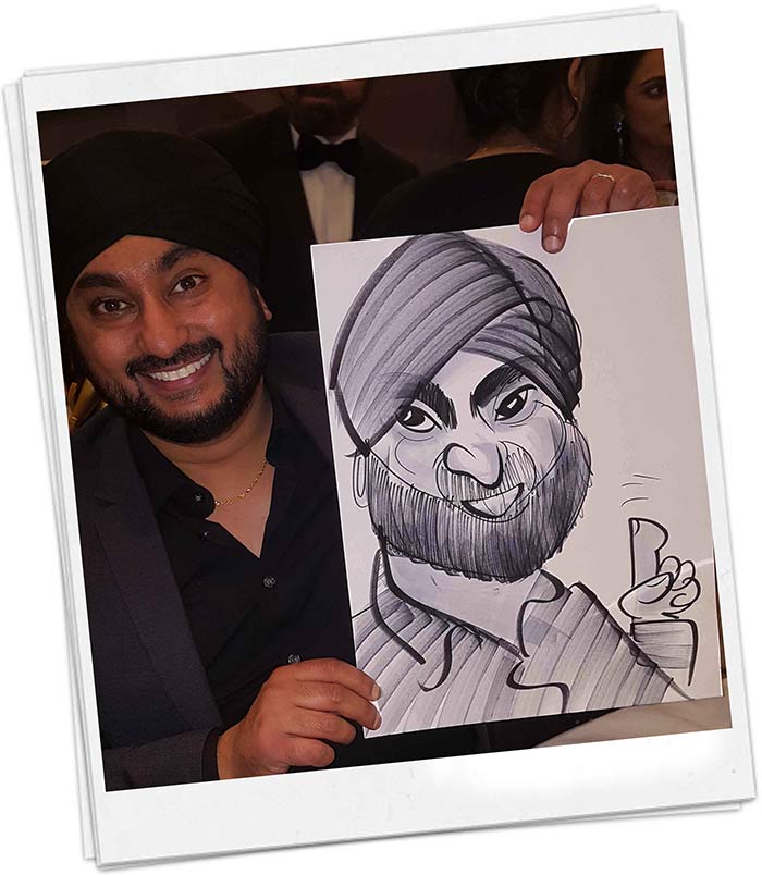 Man with Turban posing with a caricature at a Asian Wedding
