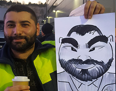 guests poses with his caricature at a Company party
