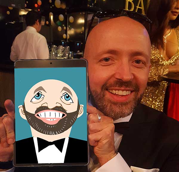 man holding up a ipad to show the caricature drawn of him