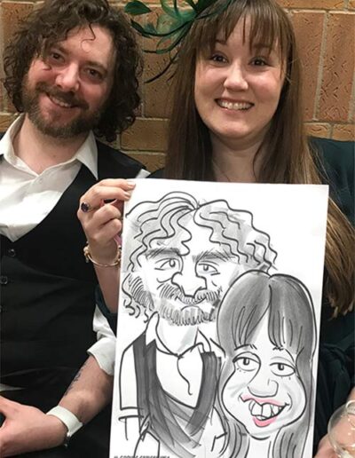 him and her hold a caricature