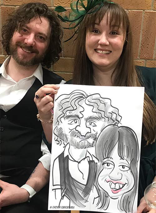 man looking like caveman and partner holding their caricature