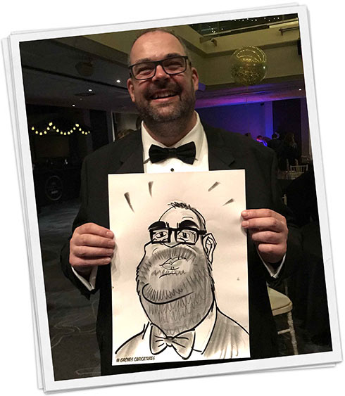 Man holding his caricature at a corporate night out
