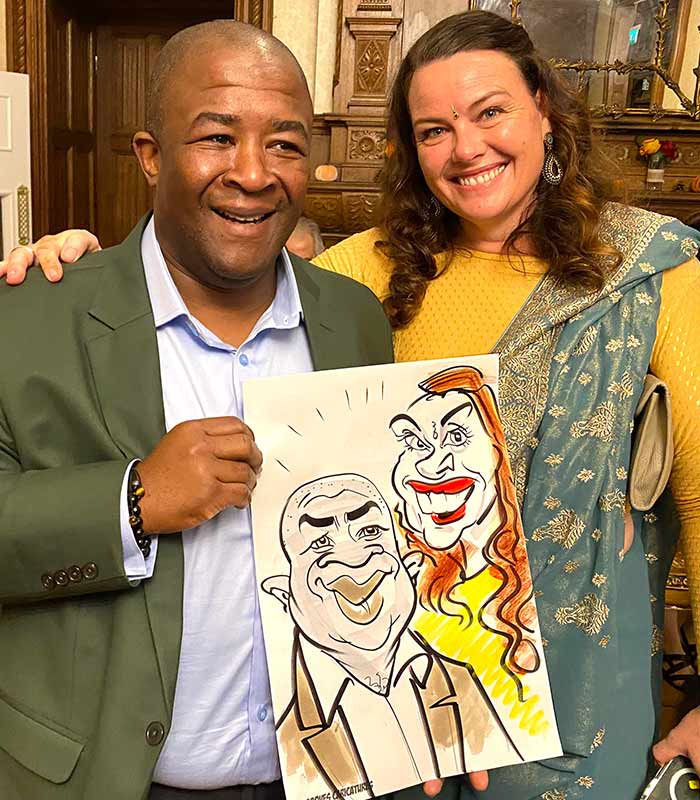 Wedding guests with caricature at Froyle Park