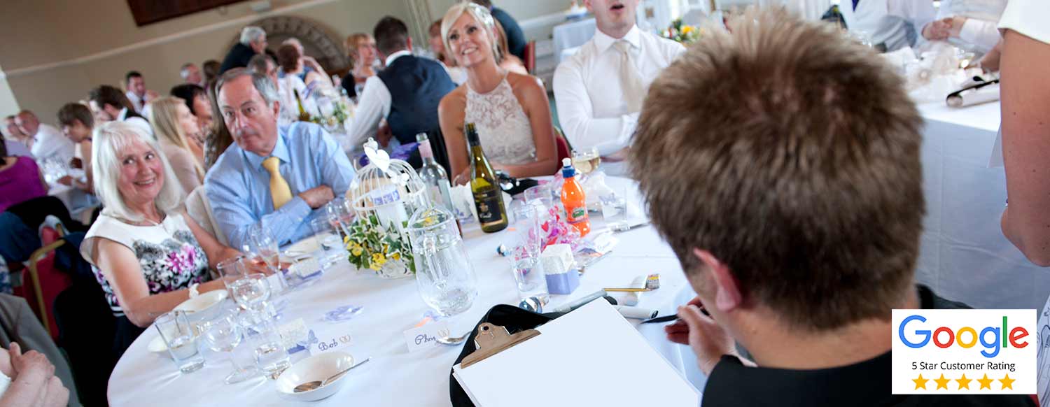Caricaturist drawing cartoons around the tables a crawley venue