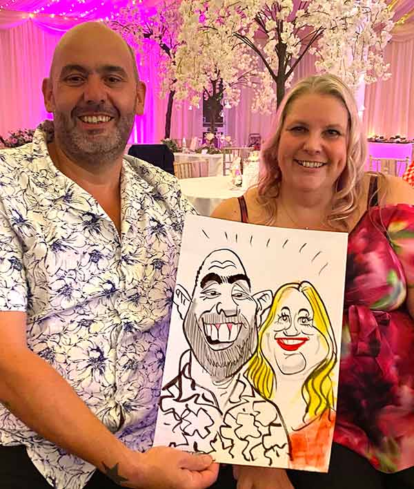 couple holding up cartoon in the new forest